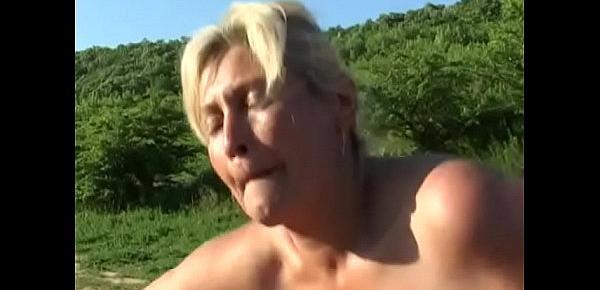  Guy fucks horny old blonde in mud outdoors